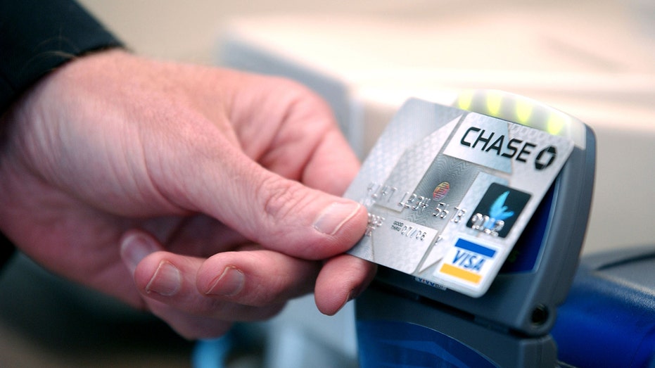 Person tapping Chase credit card on reader
