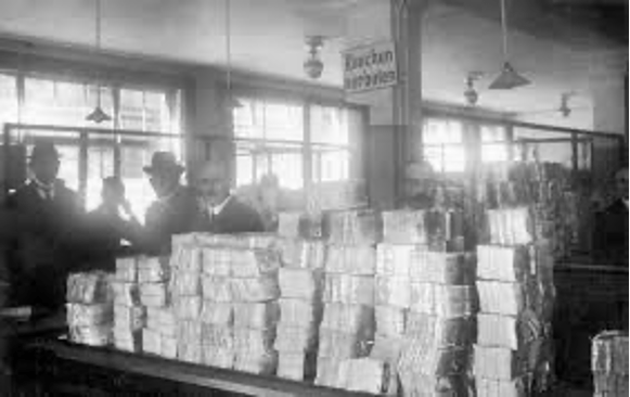 black and white photo of stacked money on counter